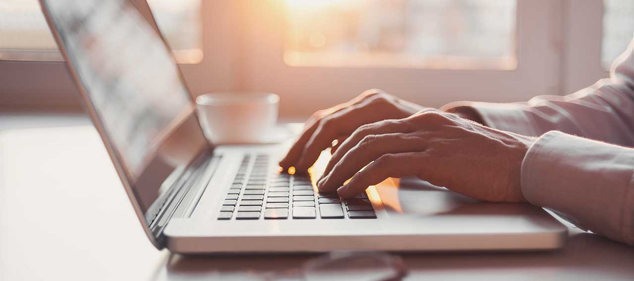 laptop typing sunset